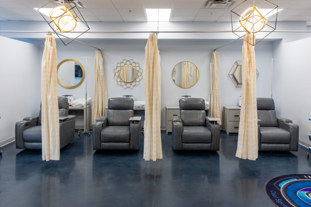 The treatment area of IntraVenous Solutions. There are 4 reclining chairs seperated by curtains. Patients will sit here to recieve IV therapy near Brentwood, TN.