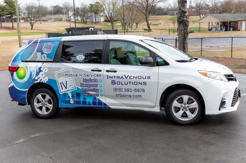 The IntraVenous Solutions mobile IV van with colorful decals parks outside of a client's chosen location, where the nurses administer IV infusion therapy at home in Nashville.