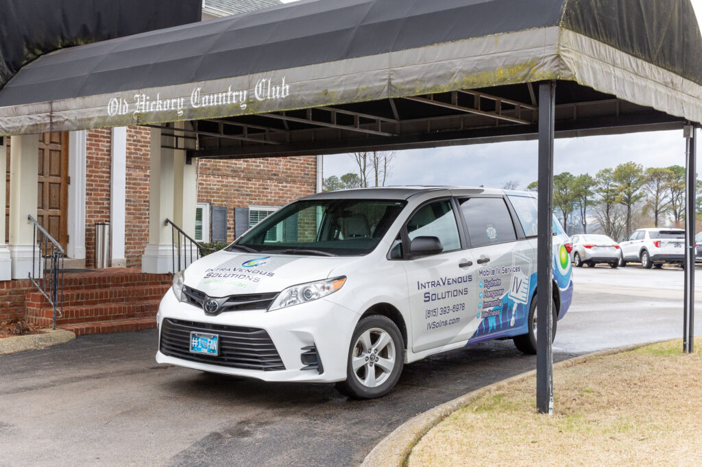 IntraVenous Solutions' mobile service van parks under an awning at Old Hickory Country Club. Here, a nurse brings mobile IV services to clients and helps answer the question: What is NAD IV therapy in Nashville?