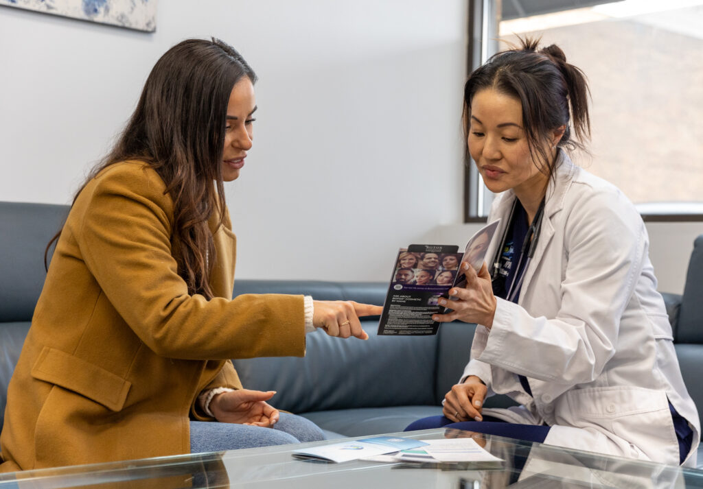 One of the providers at IntraVenous Solutions speaks with a patient about her options for IV nutrition in Nashville while sitting on a couch at IntraVenous Solutions. 