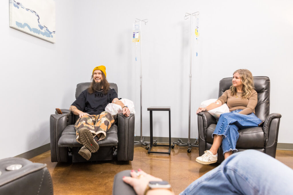 Clients sit in lounge chairs receiving IVs, reflecting wellness-focused company retreat ideas in Nashville.