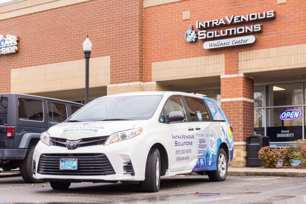 A mobile IV van parked outside of IntraVenous Solutions.